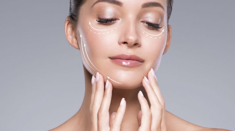 Manicure nails hand touching woman face clean fresh skin